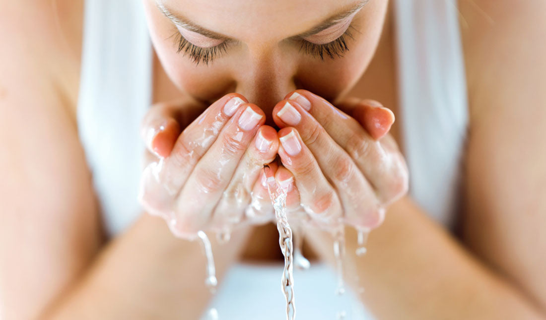 pretty lady splashing water on her face