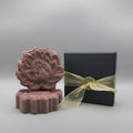 purple shampoo bar sitting next to a black box with gold ribbon