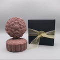 Purple shampoo bar for curly hair sitting next to a black box with gold ribbon