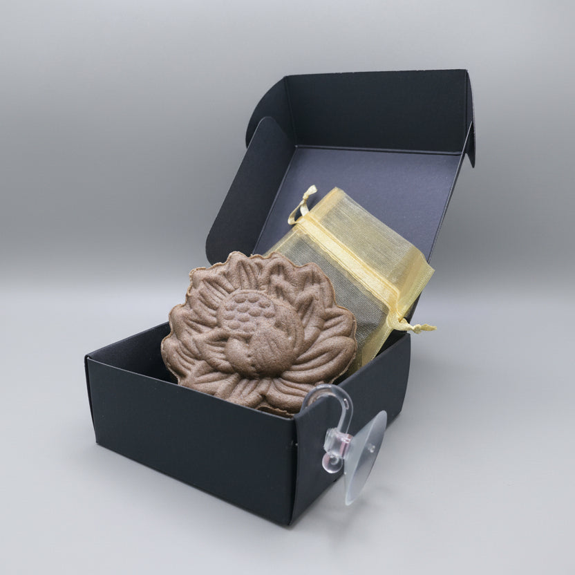 Brown shampoo bar with black box, gold organza pouch and clear suction cup