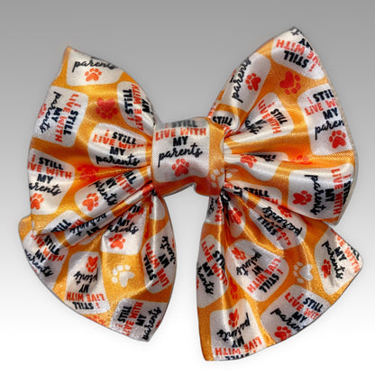 Orange with red paw prints Pet Bowtie front view with words "I still live with my parents" Sailer Necktie