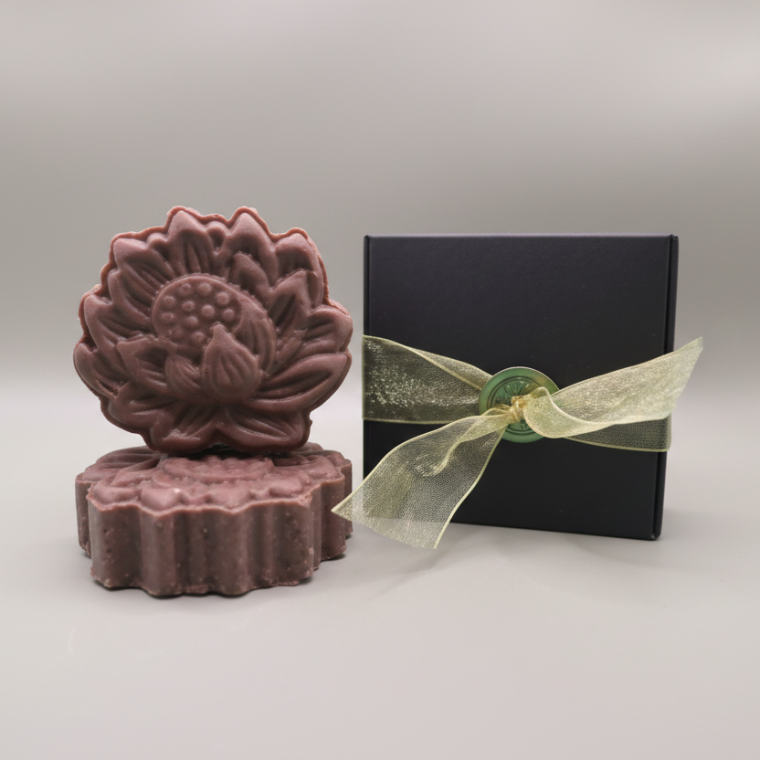 purple shampoo bar with black box wrapped in gold ribbon